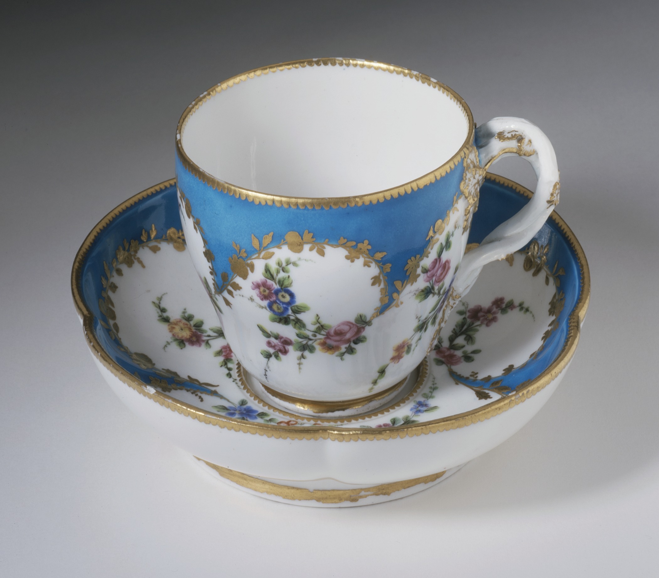 Imperial gold-trimmed porcelain cup and saucer set